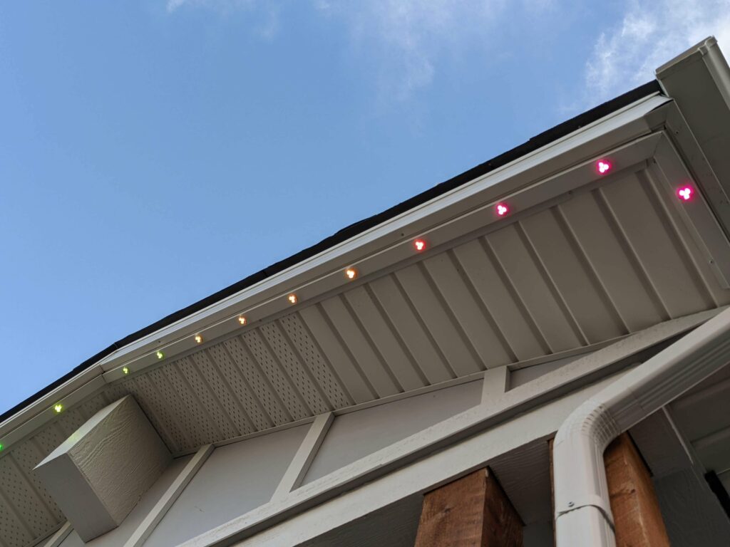 Permanent accent lighting glowing along a roofline at dusk